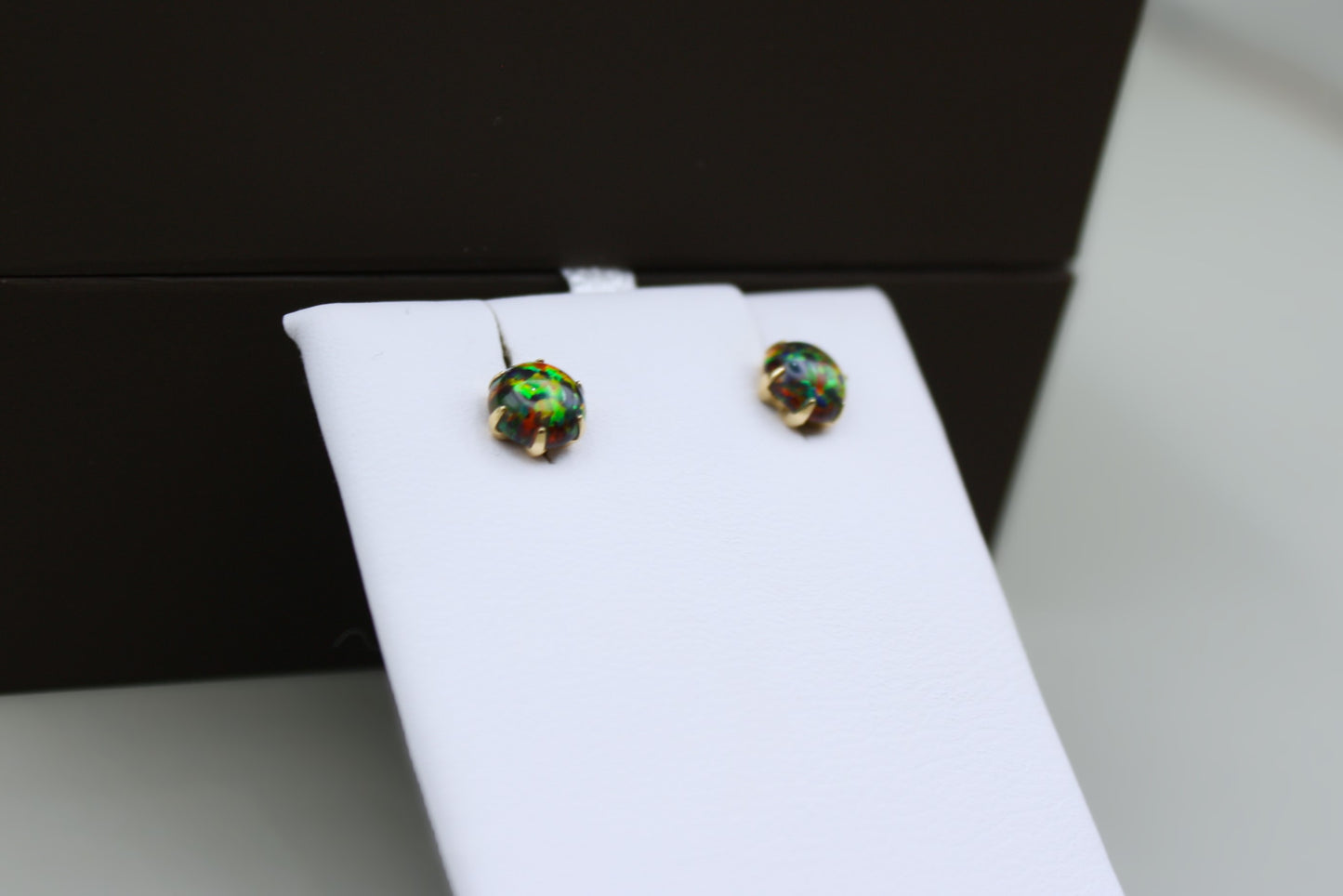 Black Fiery Kyocera Opal Round Stud Earrings in 14K Yellow Gold