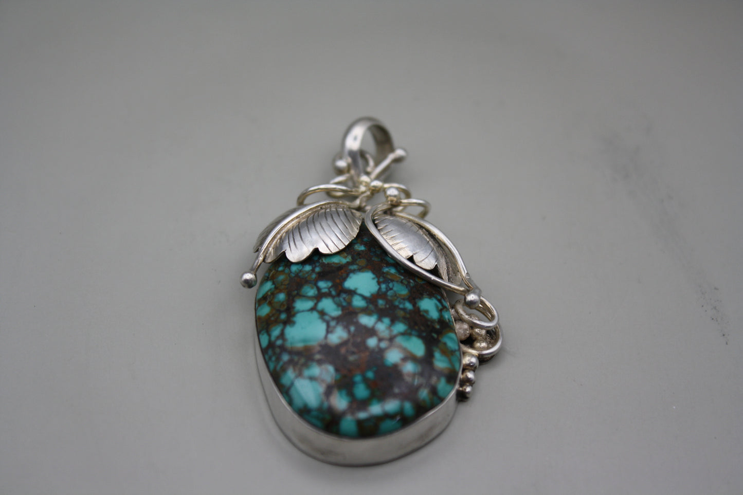 Sterling Silver Turquoise Cabochon Pendant: Nature-Inspired Foliage Wrap