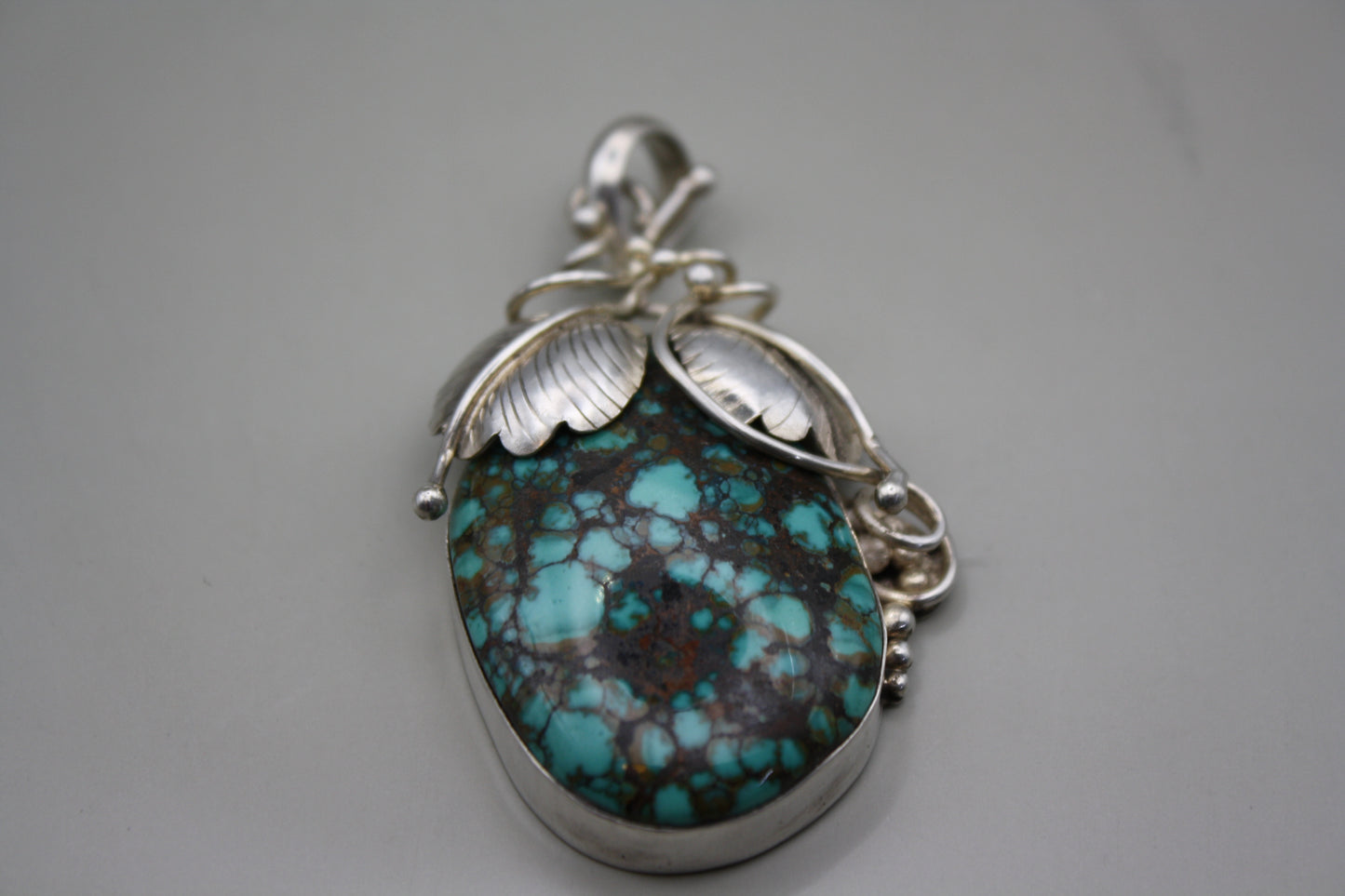 Sterling Silver Turquoise Cabochon Pendant: Nature-Inspired Foliage Wrap