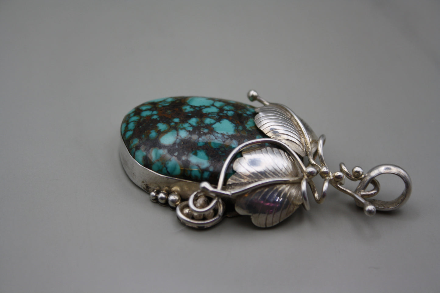 Sterling Silver Turquoise Cabochon Pendant: Nature-Inspired Foliage Wrap