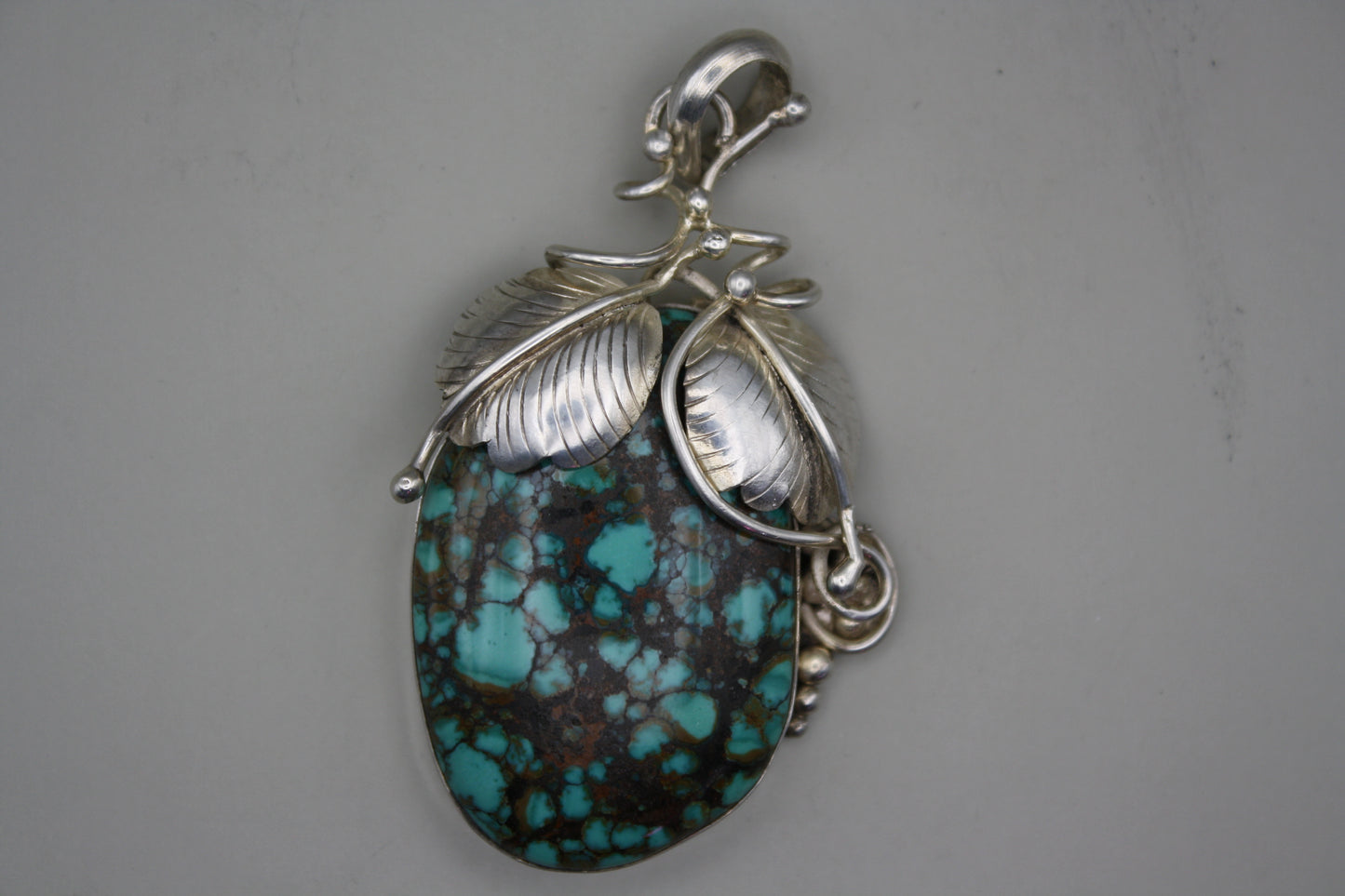 Sterling Silver Turquoise Cabochon Pendant: Nature-Inspired Foliage Wrap